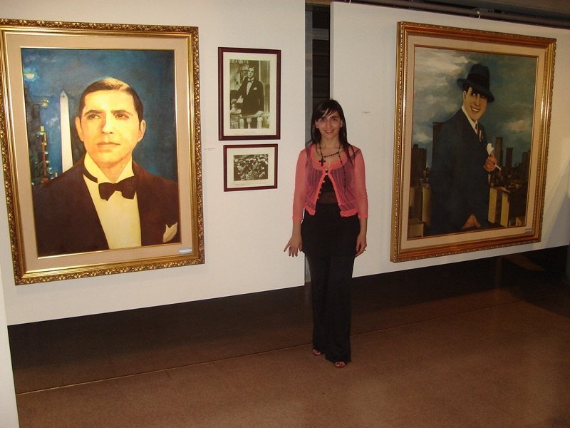 Saide between her paintings